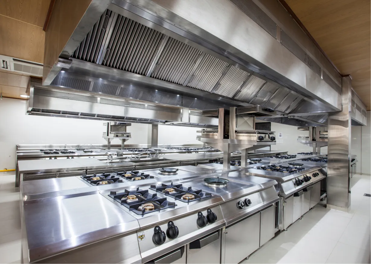 Professional kitchen with stainless steel counters and stoves